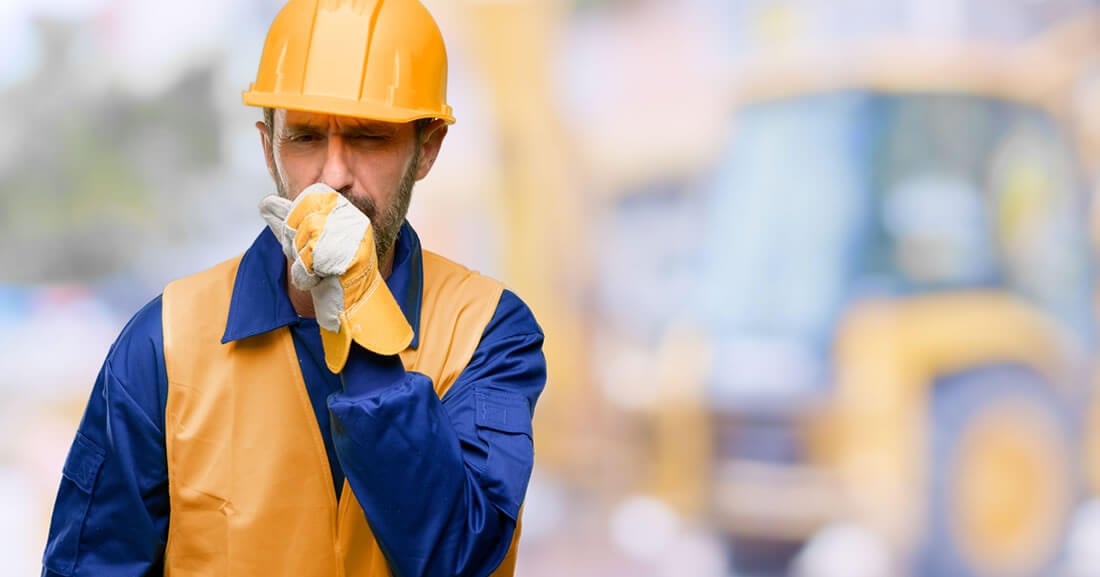 construction services image of construction worker coughing into hand as they work on site cleaned by Hunter Best